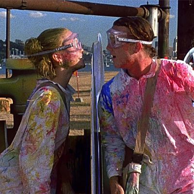 two people standing next to each other with paint all over their face and one person wearing goggles