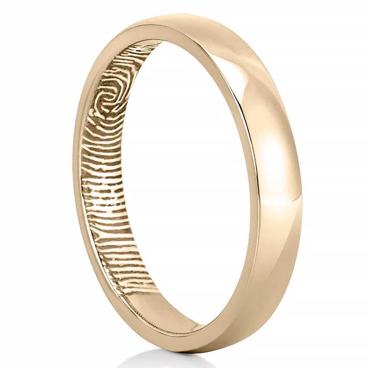 a rose gold wedding ring with an engraved fingerprint