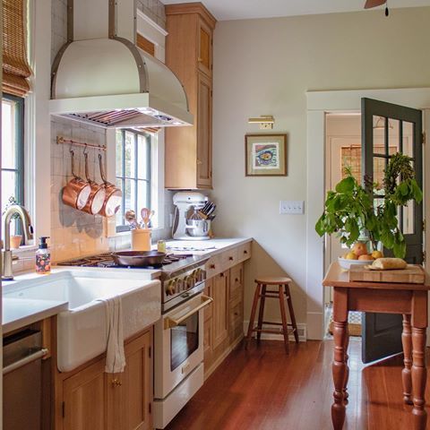 a kitchen with wooden floors and white walls