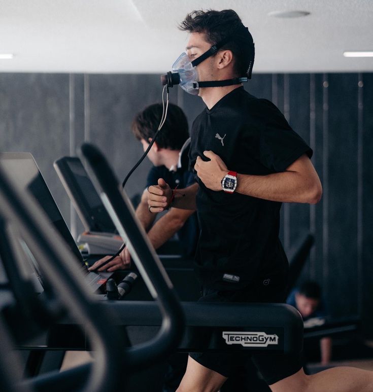 a man is running on a treadmill while wearing a face mask to protect him from the sun