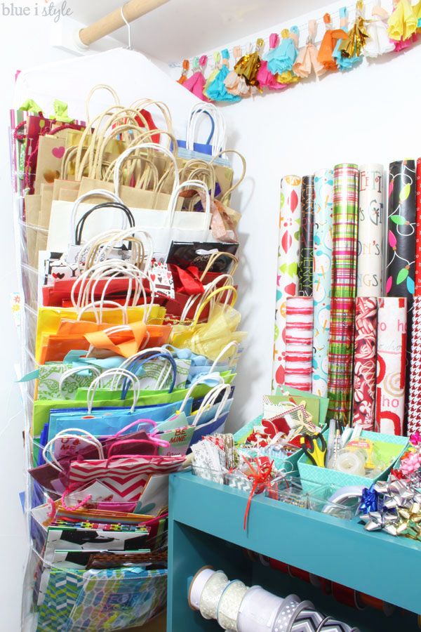 many bags and purses are on display in the closet, with ribbons hanging from the ceiling