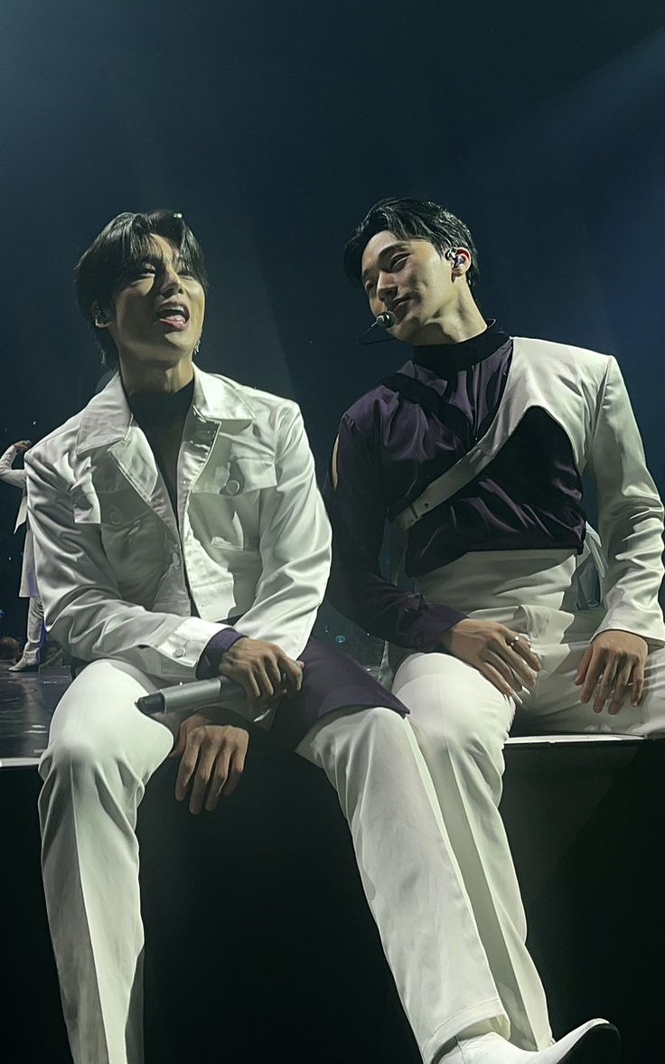 two young men sitting next to each other