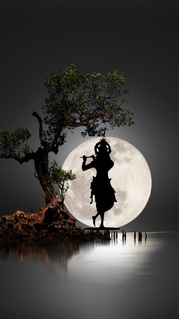 the silhouette of a person standing next to a tree in front of a full moon