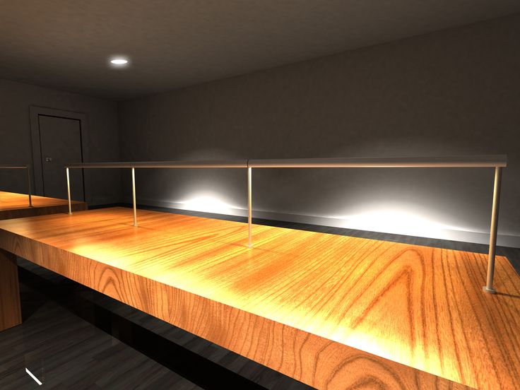 an empty room with some lights on the wall and wood flooring in front of it