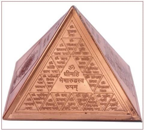 a triangle shaped metal object with writing on it