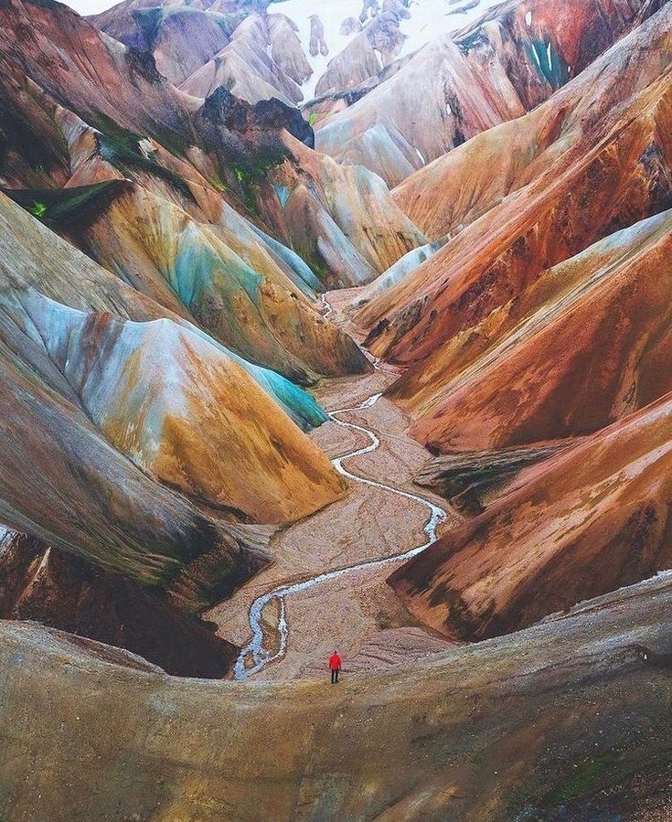 two people are standing in the middle of a valley