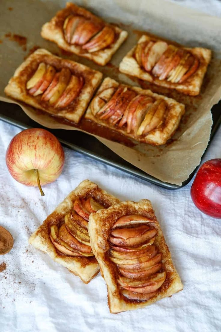 apple tarts on a baking sheet and some nuts