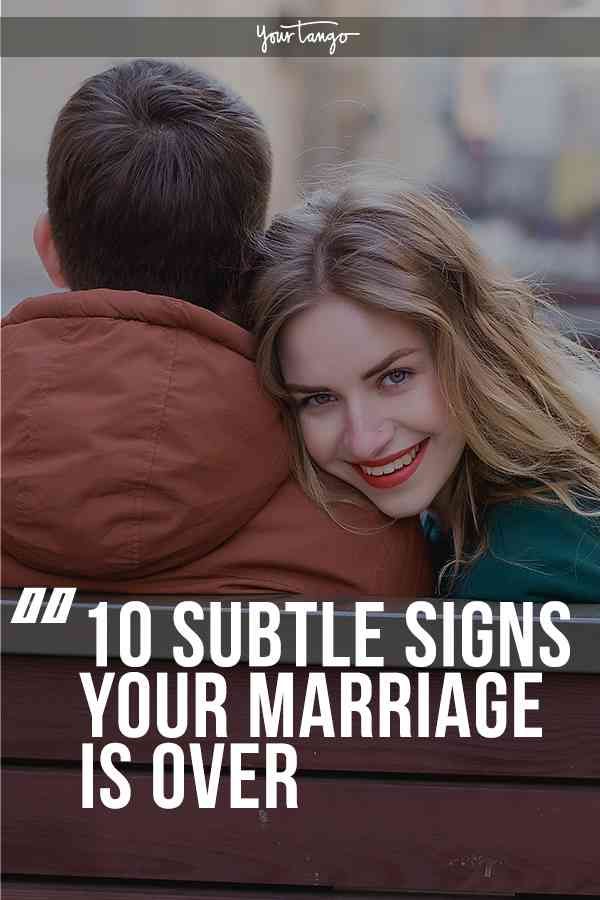 a man hugging a woman on top of a bench with the caption 10 subtle signs your marriage is over