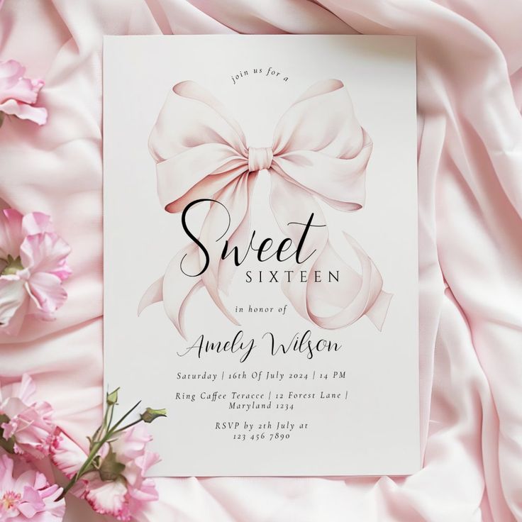 a white sheet with pink flowers next to it and a card that says sweet sixteen