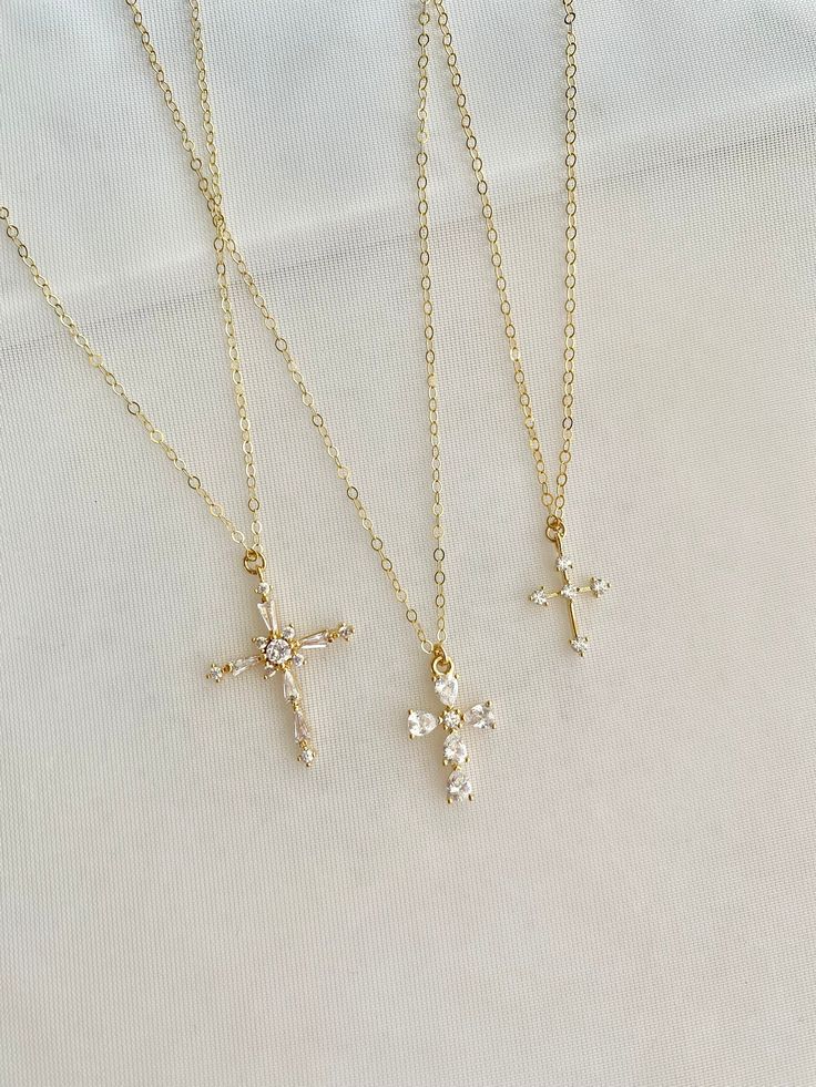 Stunning Pave Cubic Zirconia cross necklaces.  Take your pick. Gorgeous gift necklace, baptism or dedication gift.  Beautiful bridal necklaces too.   - Pendants - CZ + 14k gold plated brass - tarnish resistant - Chain + components - 14K Gold-filled  - Lobster Clasp - 14K Gold-filled   Cross #1 - 20mm x 27mm Cross #2 - 11mm x 16mm Cross #3 - 11mm x 14mm Listing is for one cross.  Choose from the pulldown menu. . . . . . . . . . . . . . . . . . . . . . . . . . . . . . . . . . .  Necklace arrives p Delicate Cross Jewelry For Wedding, Delicate Cross Necklaces For Weddings, Delicate Cross Necklace For Wedding, Cubic Zirconia Crucifix Necklace For Gift, Gold Cross Jewelry For Confirmation, Dainty Cross Pendant Jewelry For First Communion, Dainty Cross Pendant Necklace For Baptism, Elegant Cross Pendant For Confirmation, Dainty Gold Cross Necklace For Baptism