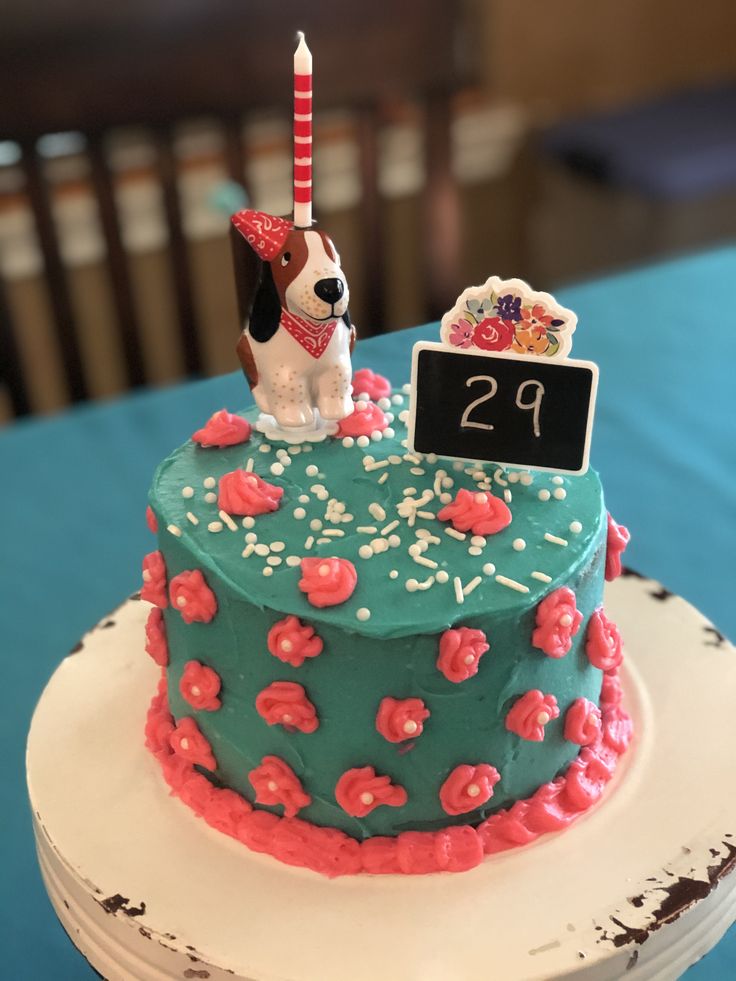 a birthday cake with a dog on top