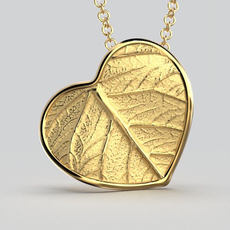 Elevate your style with our Italian 14k or 18k gold heart pendant and chain. Inspired by the beauty of nature, this exquisite heart pendant features a delicate leaf motif, infusing elegance and charm into every detail. Crafted with precision in Italy, this enchanting piece is a symbol of love and sophistication. A perfect accessory to cherish or to gift to someone special. 14k or 18k gold 20 mm high 20 mm large 18k Rolò chain chain length 45cm chain thickness 1.5mm designed and crafted in Italy