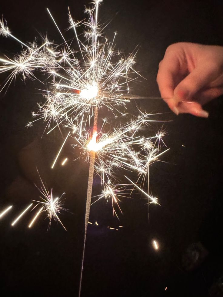 someone is holding a sparkler in their hand