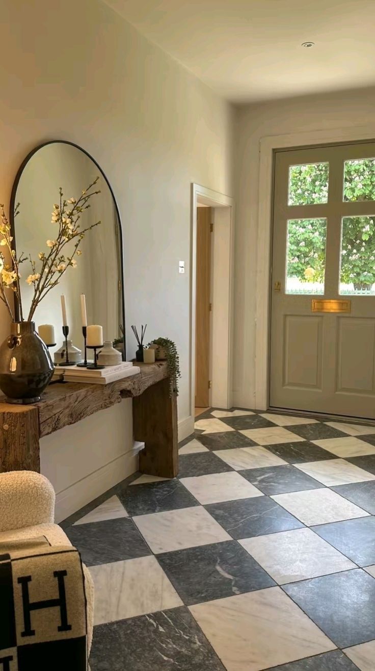 a checkered floor in a house with mirrors on the wall and candles on the table