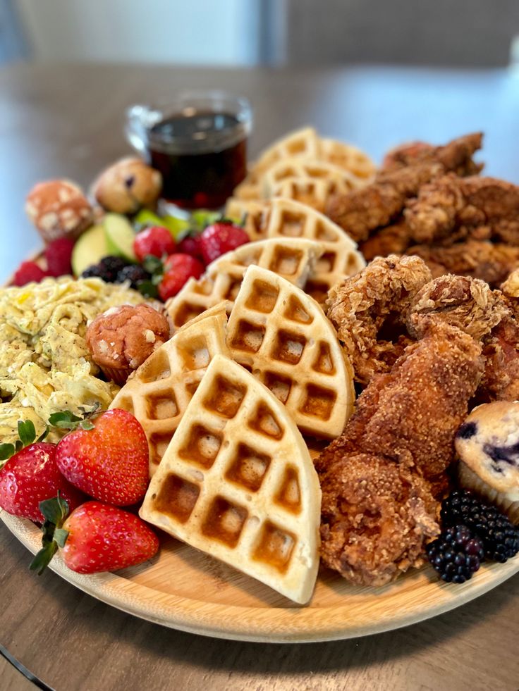 fried chicken and waffles on a plate with fruit