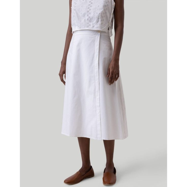 Elevate your wardrobe with our Reistor Overlap Midi Skirt! This elegant white midi skirt boasts a wrap-style design featuring chic button detailing along the side, adding a touch of classic sophistication to your look. Crafted for a regular fit with an elasticated back, this versatile skirt is ideal for a range of occasions, be it casual outings or formal events. Perfect for summer, this skirt effortlessly complements various tops and shirts, making it an essential addition to your women's summe Front Twist Top, Midi Skirt White, Linen Shorts Women, Boxy Crop Top, Overall Skirt, White Midi Skirt, Embroidered Midi Dress, Trendy Top, White Midi