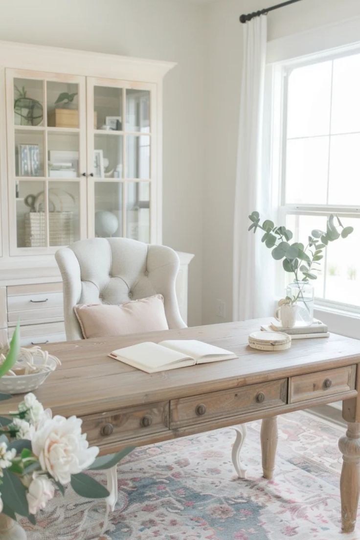 Bright, cozy reading nook with a plush chair beside a window, a wooden coffee table with an open book, surrounded by calming neutral tones and plant accents. Study Ideas Room Home Office, Study Styling, Feminine Home Office Classy, Feminine Office Space, Feminine Home Office, Feminine Home Office Ideas, Feminine Home, Country Office, Glam Office