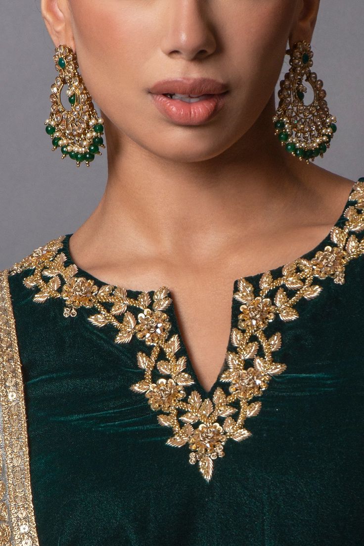 HOORIA A Beautifully embellished velvet shirt with detailed hand embroidery. Very fine Dabka, Nakshi and Kundan work. Paired with brocade pant and net dupatta with stunning sequins work. This sultry ensemble will make an exellent addition to your formals wardrobe. color: bottle green /gold Sizes: 34-50 EU size Delivery: Orders will be delivered after aprox. 2-3 weeks of placing order. In doubt about your size? click here Earrings in picture can be bought here Neck Design For Velvet Suit, Suit Hand Work Design, Zardosi Embroidery Neck Designs, Dabka Embroidery, Velvet Zardosi Work, Festive Gold Unstitched Suit With Intricate Embroidery, Festive Unstitched Suit With Gold Embroidery Fitted, Anarkali Back Neck Designs, Embroidery Dupatta