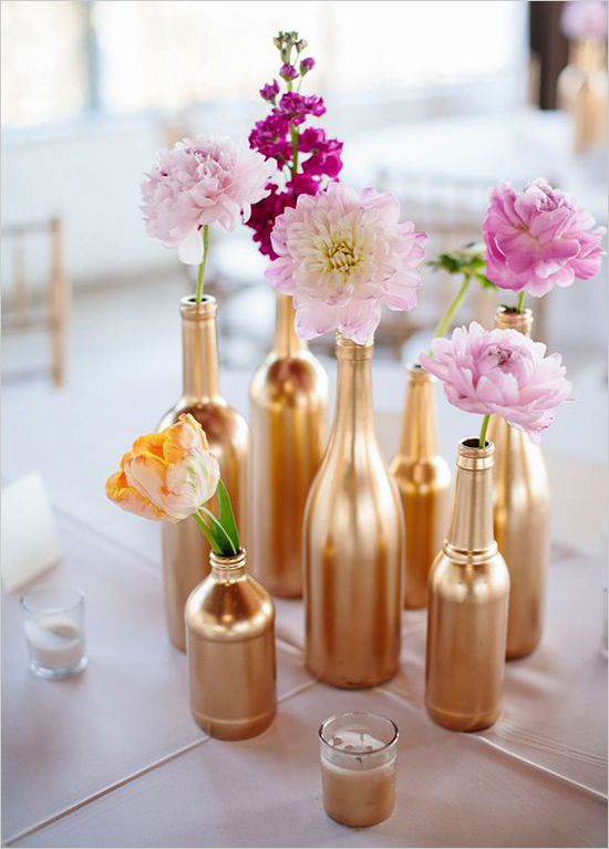 several vases with flowers in them sitting on a table