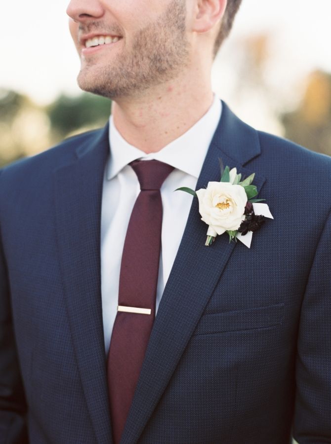 a man in a suit with a flower on his lapel