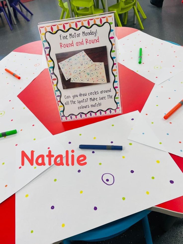 the table is set up with colorful paper and crayons