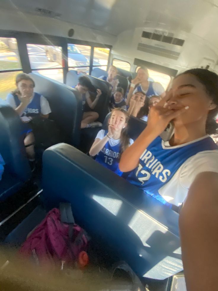 a group of people riding on the back of a bus