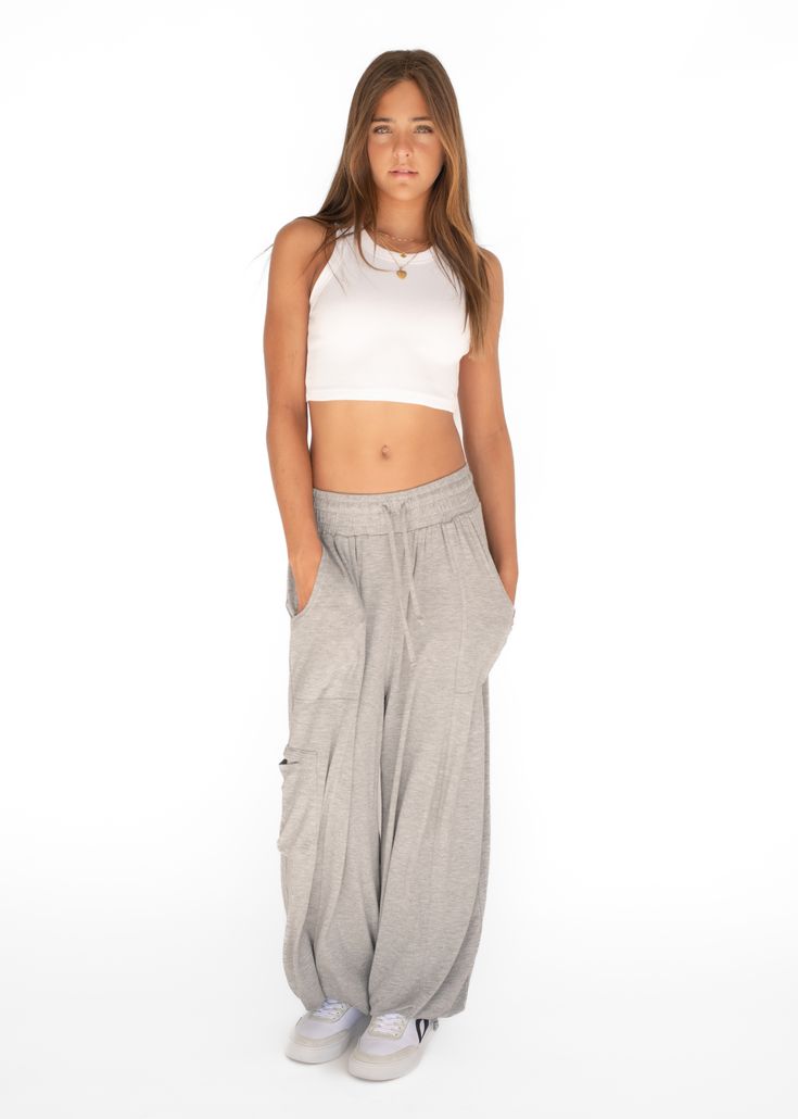 Introducing our Palazzo Pant, aka the pant of the summer. Made from an ultra soft cotton blend, it pairs perfectly with the Ribbed Racerback and Cropped Crew. You will never want to take them off and we don't blame you. Oversized fit Adjustable drawstring at the waist and ankle Made in Los Angeles Palazzo Pant, Fashion Joggers, Palazzo Pants, Turks And Caicos Islands, Brunei, Trinidad And Tobago, Oversized Fits, Fabric Care, Heather Grey