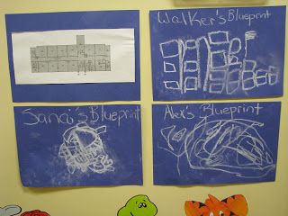 three blue and white posters with writing on them in front of a wall mounted bulletin board