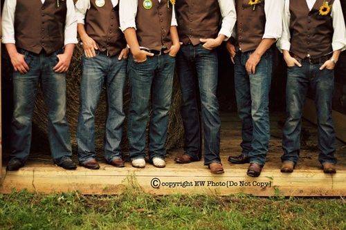 a group of men standing next to each other wearing brown vests and hats with sunflowers on them