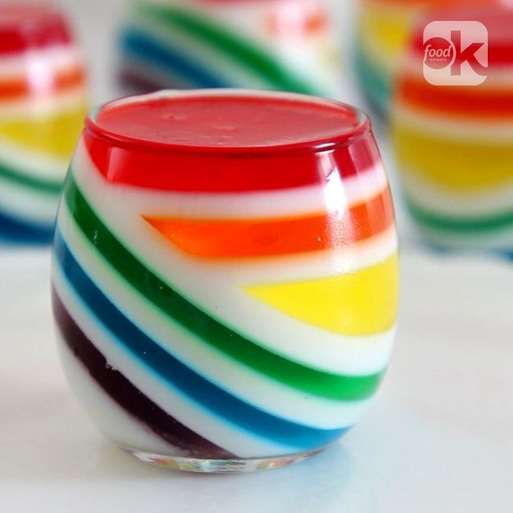 colorful striped glass sitting on top of a white table