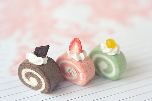 three miniature cakes sitting on top of a piece of paper