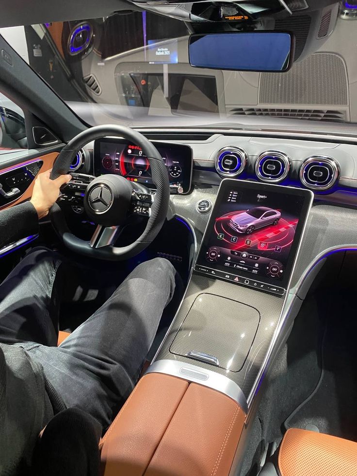 the interior of a car with an electronic touch screen and steering wheel, along with dashboard lights