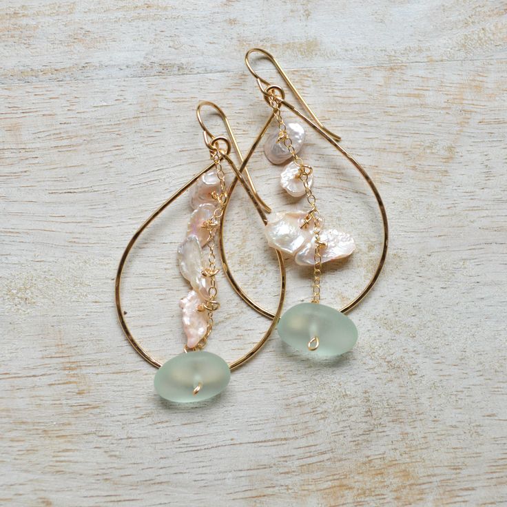 Add a touch of whimsy to your look with these unique Keshi Pearl & Frosted Glass Teardrop earrings. Handmade in Hawaii, these dainty earrings feature delicate freshwater pearls in a soft pink hue, dangling from a gold filled chain with a hint of sea foam frosted glass. A playful addition to any outfit! Made in Honolulu, Hawaii Soft pink freshwater Keshi pearls Sea foam frosted glass Hammered teardrop measures approximately 1.5" long and weighs 19g. Delicate Nickel-free Teardrop Pearl Earrings, Delicate Teardrop Wire Wrapped Pearl Earrings, Delicate Teardrop Pearl Earrings Nickel-free, Delicate Teardrop Pearl Earrings Nickel Free, Elegant Wire Wrapped Drop Hoop Earrings, Dainty Teardrop Pearl Earrings For Jewelry Making, Dainty Teardrop Pearl Earrings Wire Wrapped, Dainty Teardrop Wire Wrapped Pearl Earrings, Delicate Pink Dangle Pearl Earrings