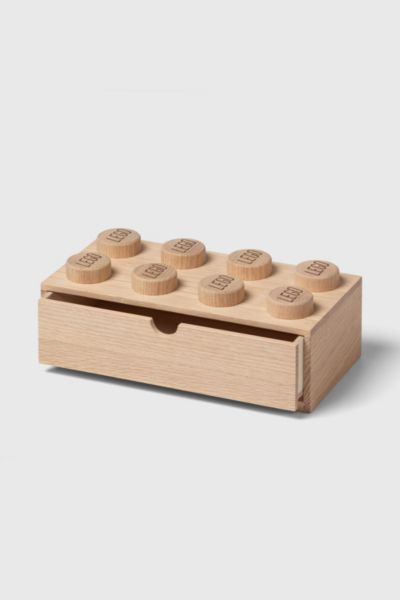 a wooden box with six small legos in it