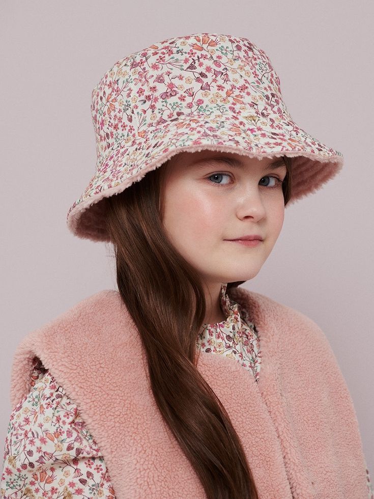 Love a good bucket hat. This Reversible Liberty Bucket Hat gives your little one two super cute options—wear the fuzzy faux sherpa on the outside, or flip it over for a pretty Liberty of London micro floral pattern. Suitable for ages 3+. Bucket Hat Fuzzy, Teddy Bucket Hat, Teddy Hat, Teddy Fabric, Reversible Bucket Hat, Liberty Of London Fabric, Soft Teddy, Liberty Of London, Double Face