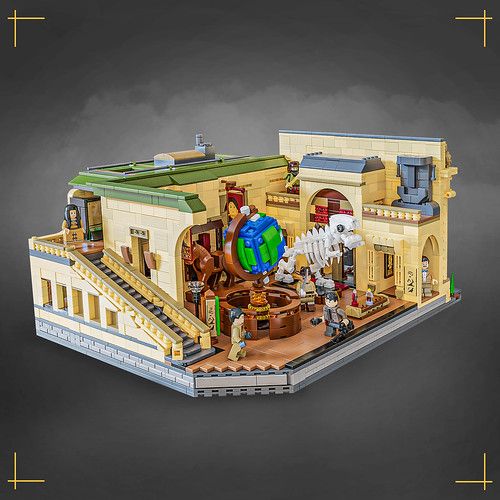 a lego model of a building with people and animals on the outside, in front of a gray background