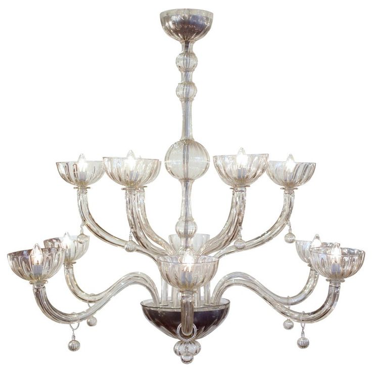 a chandelier with many lights hanging from it's sides and four candles on each side