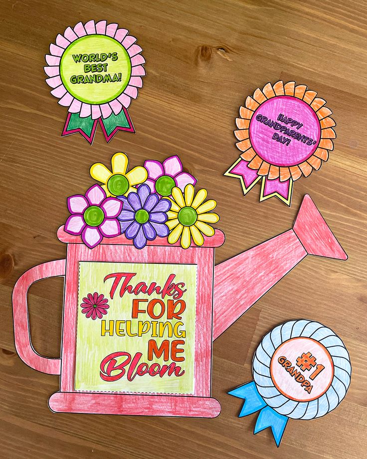 a drawing of a watering can with flowers and ribbons around it on a wooden table