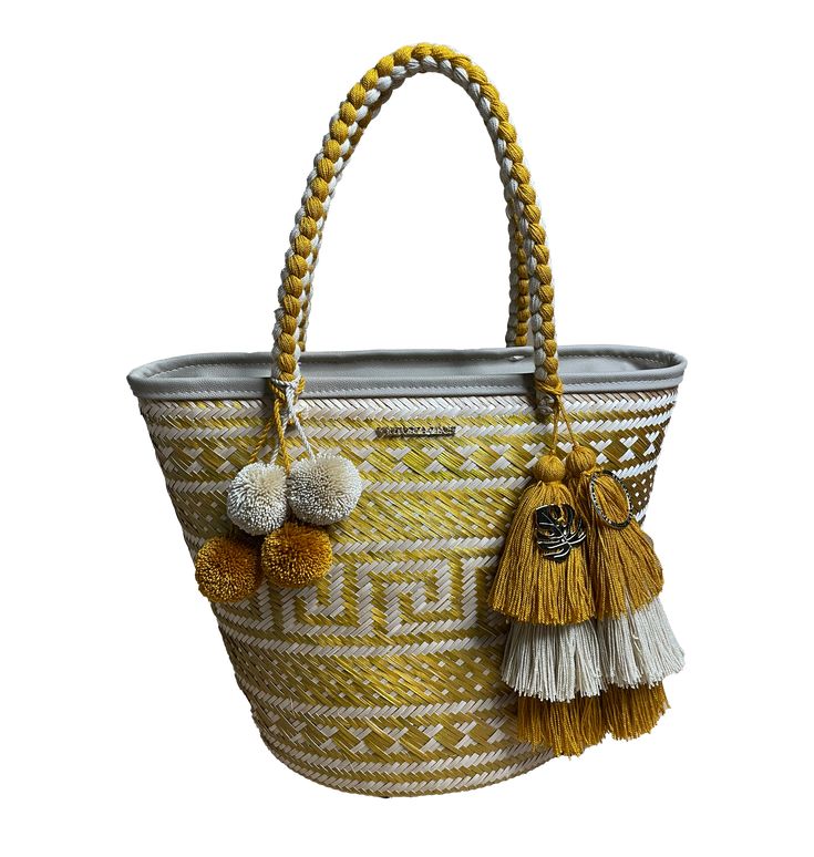 Product Description Big beach bag, this style bag is woven by our artisans from the Wayuu community Hand-braided handles Colored tassels and pompoms that match the bag are made with cotton thread Product Composition, Material, & Fabric Description Piece: Cane "Flecha" Palm // Lining Fabric: Polyester Made with the need to publicize the beauty of our Wayuu culture embodied in products made by hand The "caña flecha" palm is a soft, fresh, light material, resistant to the sun, heat, and sand Offeri Bohemian Crochet Bag With Tassels For Beach Season, Bohemian Straw Bag With Tassels For Beach Season, Beige Tassel Bucket Bag For Vacation, Bohemian Braided Bags For Vacation, White Fringed Shoulder Bag For Beach, Summer Travel Crochet Bag With Weaving Detail, Summer Travel Crochet Bag, Summer Travel Crochet Weaving Bag, Bohemian Straw Bag With Fringe For Beach