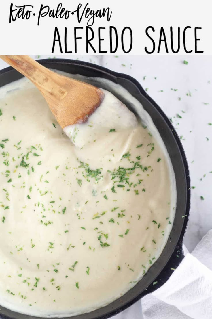 a skillet with cream sauce in it and a wooden spoon resting on the side