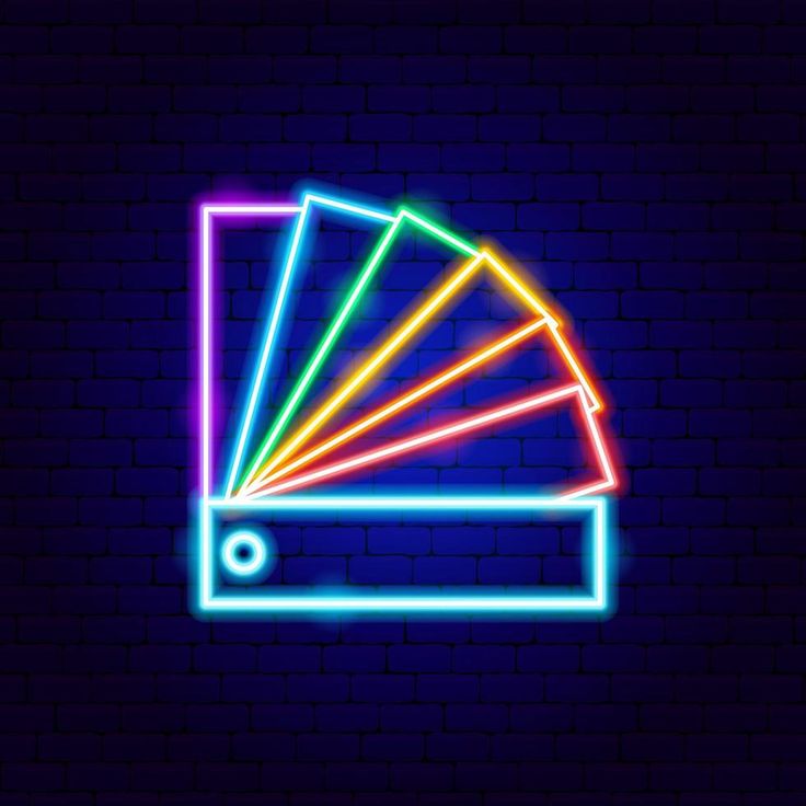 an image of a color wheel on a brick wall with neon lights in the dark