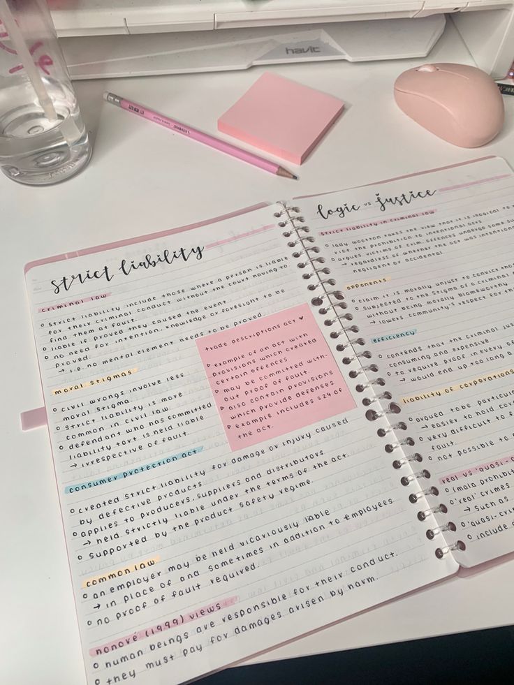 an open notebook sitting on top of a desk next to a mouse