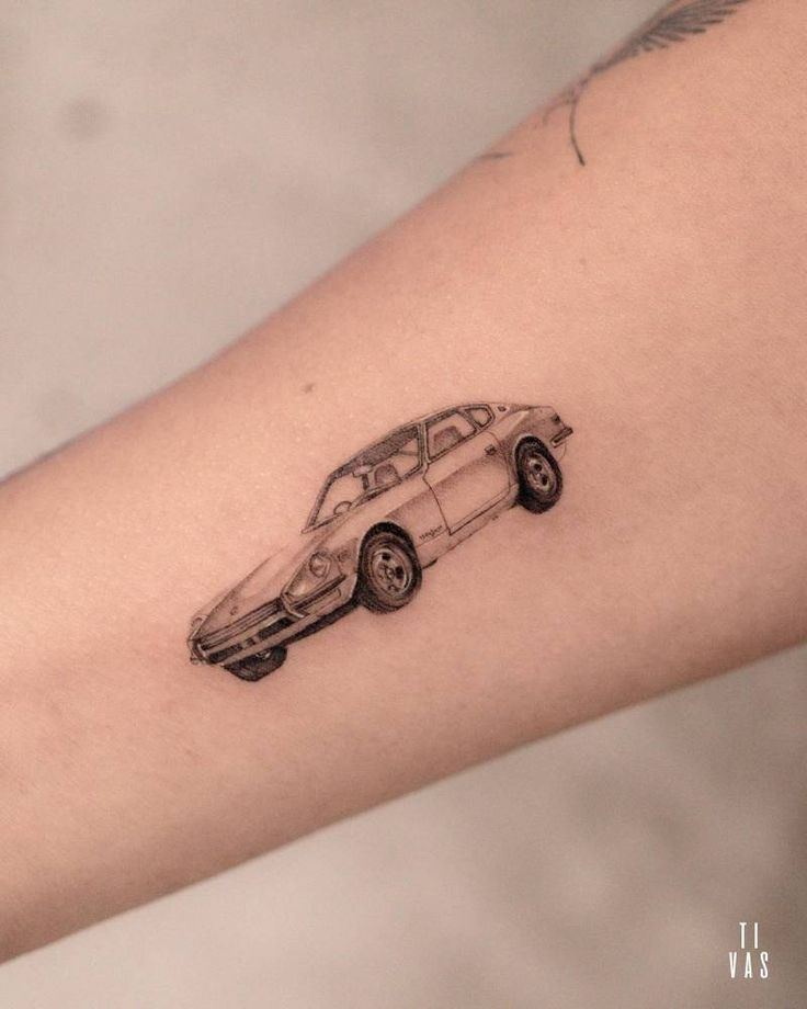 a small car tattoo on the arm