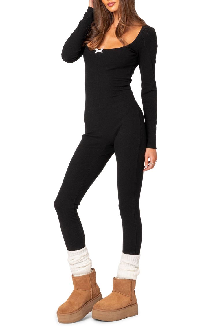 A stretchy ribbed design adds to the endless comfort of this cozy jumpsuit designed with long sleeves and a wide scoop neckline detailed with a dainty bow. Pull-on style Scoop neck Long sleeves 45% polyester, 45% rayon, 10% spandex Machine wash, dry flat Imported Long Sleeve Bodysuit For Loungewear In Fall, Ribbed Stretch Bodysuit For Fall, Fall Long Sleeve Stretch Unitard, Winter Long Sleeve Unitard With Thumbholes, Black Stretch Ribbed Jumpsuits And Rompers, High Stretch Long Sleeve Unitard For Fall, Fitted Jumpsuits And Rompers For Fall Loungewear, Solid Bodysuit With Thumbholes For Fall, Stretch Solid Color Jumpsuits And Rompers For Fall