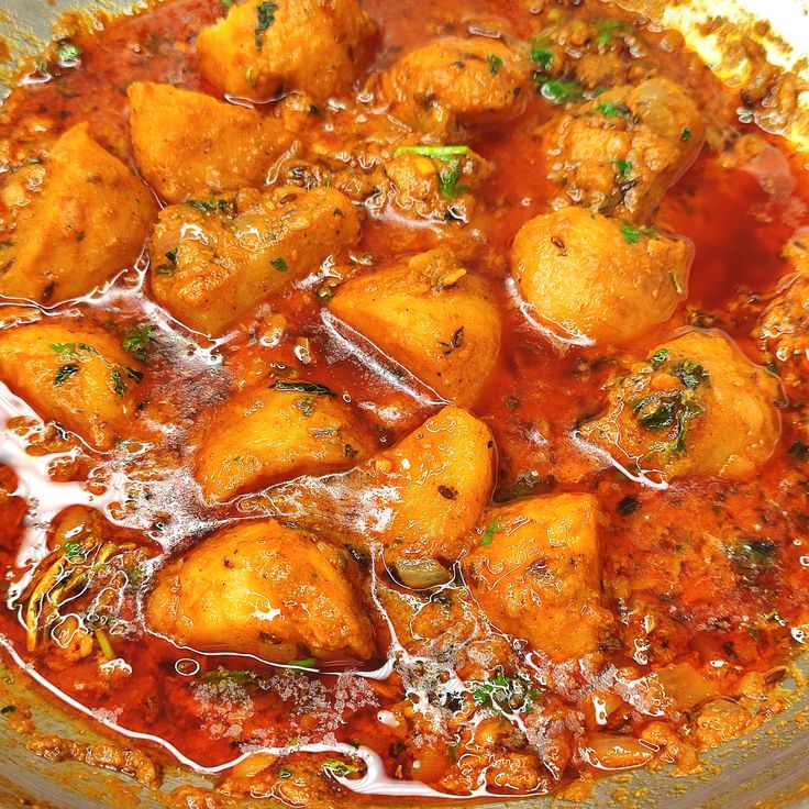 a bowl filled with food and sauce on top of a table