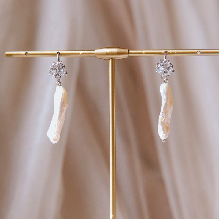 These beautiful pearl earrings come in a variety of limited edition and one-of-a-kind styles. Using a wide array of materials curated to match each style of freshwater pearl, each design is thoughtfully made to elevate your look for an evening out or an everyday touch of glamour. The materials vary by piece, with gold-filled, vermeil, and gold-plated elements. Natural stones like labradorite are featured on the Dragon's Egg pair with cubic zirconia stones featured on many others. The material ea Crimson Peak, Fine Silver Jewelry, Stone Feature, Acrylic Jewellery, The Great Gatsby, Personalized Rings, Vintage Valentines, Elevate Your Look, Fine Silver