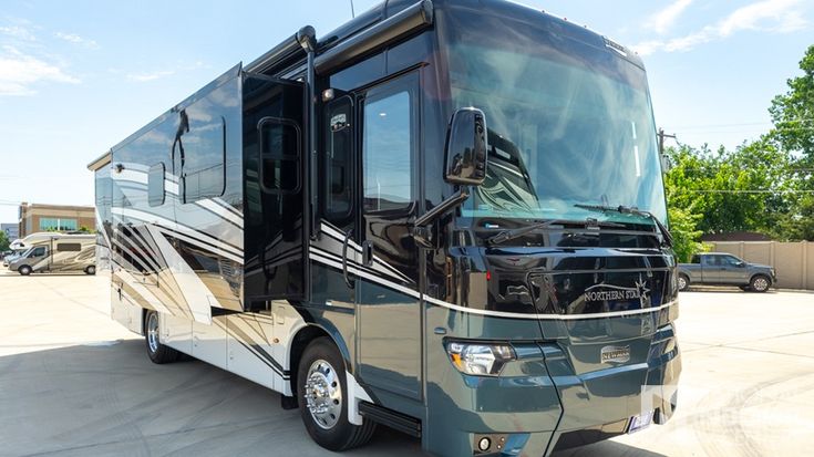 an rv parked in a parking lot with other vehicles