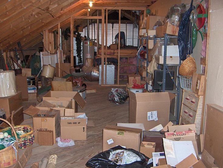 an attic with boxes and other items on the floor