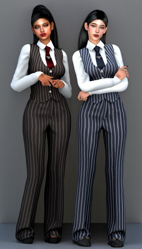 two women dressed in business attire standing next to each other with their arms crossed on their chests