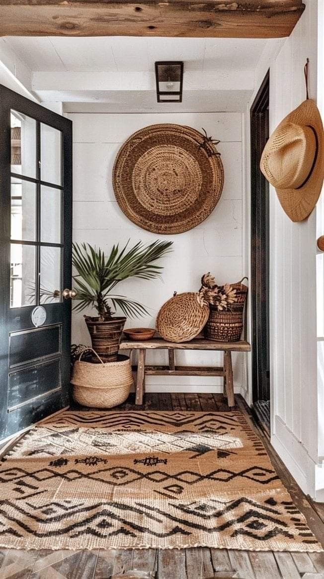 the entryway is decorated with baskets, plants and wickers on display in front of an open door